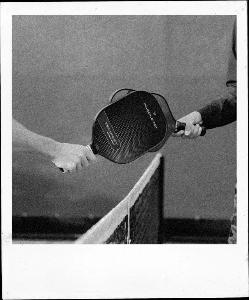 Pickleball paddle tapping at the net